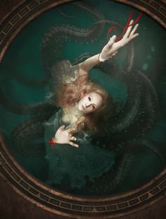 a woman with red scissors in her hand and an octopus on her shoulder is floating through the water