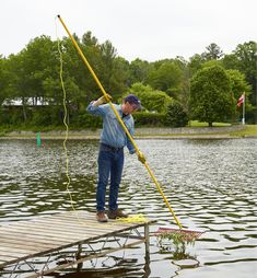 a man standing on a dock with a fishing pole