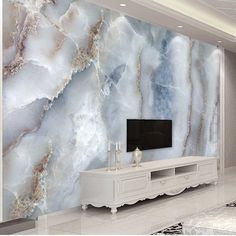 a living room with marble wallpaper and white furniture in front of the tv screen