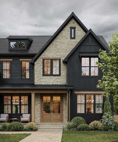 a black and white house with two story windows