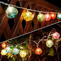 some lights that are hanging on a fence