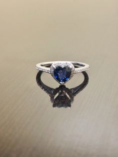 DeKara Designs Clearance A Beautiful Unique 14K White Gold Heart Shape Blue Sapphire Halo Diamond Engagement Ring. Metal- 14K White Gold, .583 Modern, Three Prong Set, Pave Set, White Gold Ring. Stones- 1 Genuine Heart Shaped Natural Blue Sapphire 0.85 Carats. 38 Round Diamonds, H Color VS2-SI1 Clarity, 0.13 Carats. Beautiful and Timeless Halo Diamond Halo Heart Shape Blue Sapphire Engagement Ring Made in 14K White Gold. The ring features a beautifully cut heart shape blue sapphire that is profe Heart Shaped Sapphire Rings For Formal Occasions, Blue Rings For Valentine's Day Formal Occasion, Sapphire Promise Ring With Brilliant Heart Cut, Tanzanite Halo Jewelry For Wedding, Heart Cut Sapphire Promise Ring With Brilliant Cut, Elegant Heart Shaped Sapphire Ring For Formal Occasions, Luxury Sterling Silver Heart Ring For Wedding, Blue Heart Cut Sapphire Ring For Formal Events, Tanzanite Halo Wedding Jewelry