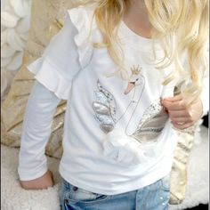 Baby Sara Girls L/S Cream Ruffle Top W/ Swan Print Applique Playful Long Sleeve Tops With Ruffles, Playful White Fitted Top, Playful Fitted White Top, Cute Long Sleeve Ruffled Shirt, Cute White Tops For Fall, Cute White T-shirt With Ruffles, Long Sleeve Ruffled T-shirt For Summer, Trendy Fringe, Fringe Blouse