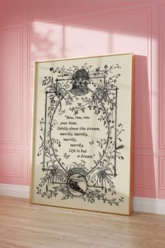 an ornate frame with a poem on it against a pink wall