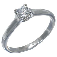 a white gold ring with a diamond in the center