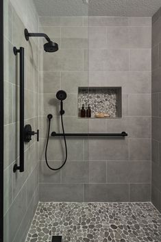 Bathroom Remodeling Ideas -  A transitional shower design with river rock floor and niche accent. Large format grey tile on the walls. Matte black fixtures. Restroom Remodel, Tub To Shower Remodel, Full Bathroom Remodel, Bathroom Redesign, Bathroom Remodel Designs, Bathroom Remodel Shower, Bathroom Inspiration Decor, Shower Remodel, Bathroom Remodel Master