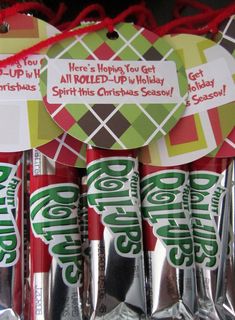 christmas candy wrapped in foil and tied with red twine on the bottom, sitting next to each other