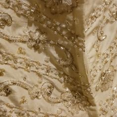 the back of a wedding dress with beads on it