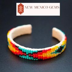 This is an adjustable/bendable/flexible to wrist bracelet. It is a Navajo beaded bracelet on soft white deerskin. Beaded cuff bendable bracelet. Southwestern, western jewelry. Navajo, tribal, pueblo jewelry. New Mexico handcrafted, Native American beadwork. Geometric, abstract beadwork. Desert style minimalist jewelry.  *approx. 1/2" wide X 6 1/8" length  *adjustable  *unisex Native American patterns and designs have symbolic meanings. The patterns are often repeated, representing the repetitive nature of our lives. The different designs are made up of one or more symbols to suggest hope and intent, to communicate with the Great Spirit and to identify certain roles and responsibilities or to record stories. Though some patterns and designs vary from one tribe to another, several designs an Adjustable Cuff Bracelet With Colorful Beads, Adjustable Bangle With Round Beads For Festivals, Adjustable Beaded Cuff Bracelet Bangle, Adjustable Beaded Cuff Bangle, Artisan Beaded Adjustable Cuff Bracelet, Adjustable Bangle With Colorful Beads, Adjustable Beaded Wristband For Jewelry Making, Southwestern Adjustable Beaded Bracelets, Adjustable Multicolor Southwestern Cuff Bracelet