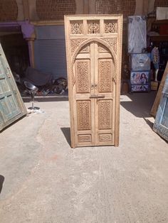 an open wooden door in the middle of a room