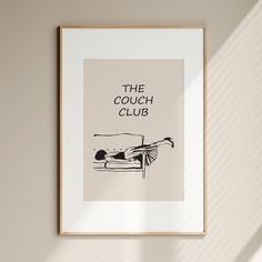 a black and white poster with the words the couch club on it in front of a beige wall