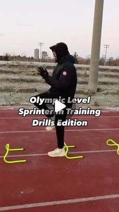 a man standing on top of a red track next to a yellow line with the words olympic level sprinter in training