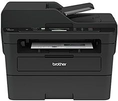 a black printer sitting on top of a white table