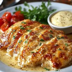 a white plate topped with meat covered in sauce