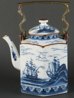 a blue and white tea pot with a handle