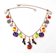 This happy and colorful Halloween charm necklace is handcrafted by myself and a one of a kind original.  The gold plated chain is 20 inches long with 17 drops containing  pumpkins, jack o lanterns, candy corn,  moons, stars, bats and lots of crystals so it sparkles as you move.  It contains an assortment of enamel charms, glass, acrylic and crystals.  If you need it shorter or longer just let me know, and I will adjust it to as close as possible to the size you desire. If you would like a charm switched to something else just ask!  Each charm is placed with thought  for color and balance.  It is  a really fun piece, and sure to make you smile for years to come. If you have any questions, please ask.  I do my best to describe items accurately. If something wouldn't be right it would be by a Themed Handmade Multicolor Necklace, Unique Handmade Halloween Necklaces, Handmade Dangle Necklaces For Halloween, Handmade Multicolor Dangle Charm Necklaces, Handmade Multicolor Charm Necklaces With Dangle, Handmade Unique Multicolor Charm Necklaces, Handmade Multicolor Unique Charm Necklaces, Handmade Themed Multicolor Jewelry, Handmade Multicolor Novelty Jewelry