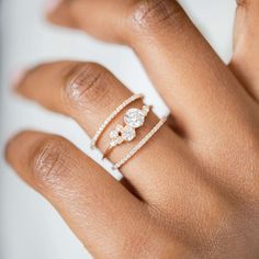 a woman's hand with two rings on it