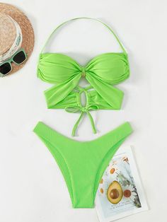 Stand out with this stylish two-piece bikini from Rita Rosa Brazilian Beachwear in vibrant green neon. The top features a center gold ring, bandage cut-out design, and crisscross back tie straps for a secure fit. Removable pads offer extra support. The thong-style bottom with a high-waisted fit accentuates your curves. Perfect for any fashion-forward beachgoer. Imported worldwide 🌍 Criss Cross Ring, Neon Printing, Beachwear Collection, Green Neon, Halter Bra, Swimwear Sets, Swimsuits Halter, Cut Out Design, Fashion Pattern