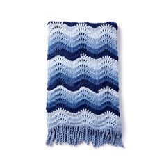 a blue and white crocheted blanket with fringes on the bottom, against a white background