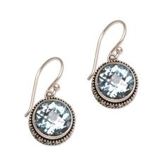 Sterling silver bezels handcrafted with dot motifs hold dazzling blue topaz stones in this pair of dangle earrings. From Komang Wijayana of Indonesia the earrings feature gemstones with a total weight of five carats. Blue Topaz Birthstone Round Earrings, Blue Topaz Birthstone Earrings, Blue Topaz Drop Earrings Gemstone Jewelry, Blue Topaz Round Pierced Earrings, Pierced Blue Topaz Round Earrings, Pierced Round Blue Topaz Earrings, Sterling Silver Round Earrings With Gemstone Accents, Sterling Silver Earrings With Gemstone Accents, Matching Round Topaz Earrings Jewelry