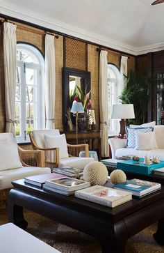 a living room filled with lots of furniture and decor on top of a wooden table