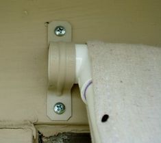 a close up of a white door handle on a wall