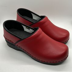 Comfy Nib Bjork Swedish Comfort Ella Red/Black Leather Clogs Shoes. Size 39-40 = Us Size 8-9.5. The Ella From Bjork Swedish Comfort Is A Classic Yet Functional Clog, Hand-Made In Europe. Genuine Leather Upper. Provides All Day Comfort, Thanks To It's Rocker Bottom, Softer Insole And Arch Support Design. Hand-Made In Europe Genuine Leather Pu Outsole With Rocker Bottom To Propel The Foot Forward While Providing A High Degree Of Shock Absorption And Arch Support Anti-Bacterial Midsole Cushioned Le Casual Clogs With Red Sole And Round Toe, Comfortable Red Clogs With Round Toe, Red Closed Toe Clogs With Cushioned Footbed, Red Synthetic Clogs With Cushioned Footbed, Casual Red Clogs With Leather Footbed, Red Clogs With Leather Footbed And Round Toe, Leather Clogs With Red Sole And Round Toe, Red Leather Clogs With Leather Footbed, Leather Clogs With Slip-resistant Round Toe