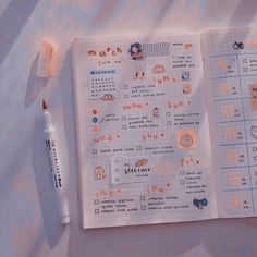 an open notebook with stickers on it next to a marker