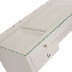 a white desk with drawers and glass top