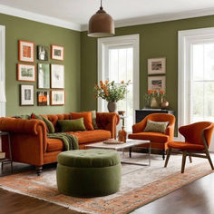 a living room with green walls and orange furniture in the center, along with pictures on the wall