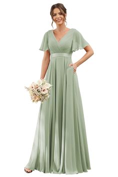 a woman in a long green dress holding a bouquet