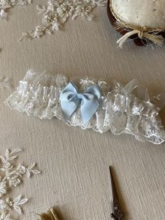 This pretty 'something blue' is a dainty ivory tulle, embroidered with flowers. Gently gathered, with a sheer, satin edged ribbon and a pretty blue bow. A lovely garter for your 'something blue'! Made in two comfortable sizes 14"-22" and a plus size 20"-26" the garter is designed to still have a little ruffle in the tulle when it's worn.  This garter would be beautiful with an ivory wedding dress! Your garter will be sent in pretty tissue, with a card for the bride. Usually in stock and dispatch Unique Garters Bridal, Something Blue Garter, Unique Something Blue Wedding, Old New Borrowed And Blue Ideas, Something Old New Borrowed And Blue, Something Blue Wedding Ideas, Something Blue Ideas, Baby Blue Wedding, Unique Garter