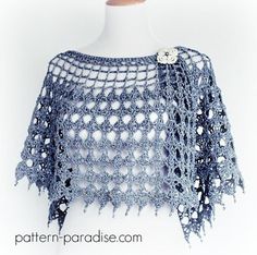 a blue crocheted shawl on a mannequin