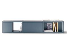 a blue shelf with books and magazines on it