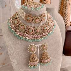 Statement bridal set made with antique plating, champagne crystals, Mint and pink gems. Finished with an abundance on tiny bead detailing in pearl, mint and ombre pink glass drops.  Set comes complete as seen with choker (1 inch wide), necklace(1.5 inch wide, Jhumka earrings (3 inch length) and statement Tikka (2.5 inch length x 2 inch width) Ready to ship with Gift Box. Bridal Survival Kit, Pakistani Bridal Jewelry, Indian Wedding Jewelry Sets, Indian Bridal Jewelry Sets, Pink And Mint, Bridal Jewellery Design, Double Necklace, Ombre Pink, Bridal Choker