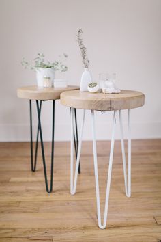 two wooden tables with metal legs and plants on them