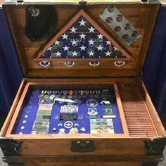 an open trunk with american flags and other items in it on the floor next to a blue table cloth