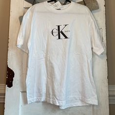 This Is A Vintage Piece, With Tags. This Is A 90s Shirt Which Is Very On Trend Right Now. Calvin Klein White Logo Print T-shirt, Calvin Klein Crew Neck T-shirt For Spring, Calvin Klein Basic Short Sleeve Tops, Calvin Klein Cotton Logo T-shirt, Calvin Klein Cotton T-shirt With Logo Print, Spring Calvin Klein Logo Print T-shirt, Spring Calvin Klein T-shirt With Logo Print, Calvin Klein Logo Print T-shirt For Spring, Calvin Klein Spring Logo Print T-shirt