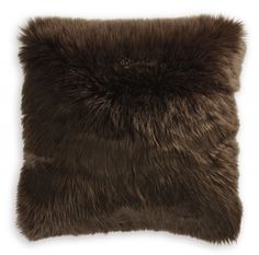 a brown fur pillow on a white background