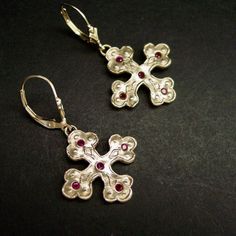 "Hand sculpted cross Byzantine earrings with embedded garnet reminiscent of ancient Greek jewelry The orthodox cross is a variation of the Christian cross since the 6th century in the Byzantine Empire. This is a square cross with clover tip shape ends. A cross with three circles or discs on each arm in a Christian context represents the Holy Trinity but was probably also copied from earlier Celtic Druidry, where the circles or rings represent the three dominions of earth, sky and sea. - Hand car Byzantine Sterling Silver Jewelry With Matching Earrings, Medieval Style Handmade Earrings For Gift, Handmade Byzantine Style Crucifix Jewelry, Traditional Handmade Crucifix Jewelry, Byzantine Cross Jewelry, Silver Byzantine Pierced Earrings, Silver Byzantine Cross Jewelry, Medieval Cross Necklace, Bronze Cross Spiritual Jewelry