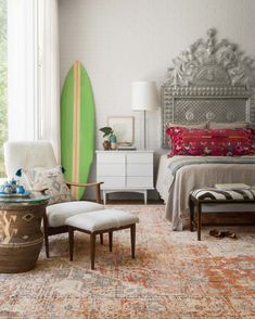 a bedroom with a surfboard on the wall