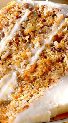 a close up of a cake on a plate with icing and crumbs