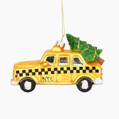 a taxi ornament with a christmas tree on top