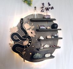 a wall mounted shelf with various items on it