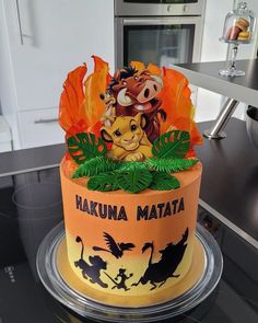 a lion themed birthday cake sitting on top of a counter