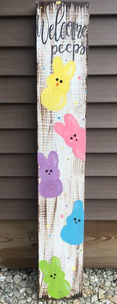 a wooden sign that says welcome peeps with colorful flowers painted on the side of it