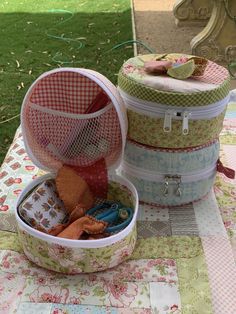 several small containers are sitting on a quilted tablecloth in the shape of suitcases