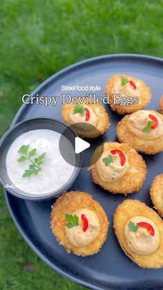 small appetizers are arranged on a plate with dipping sauce