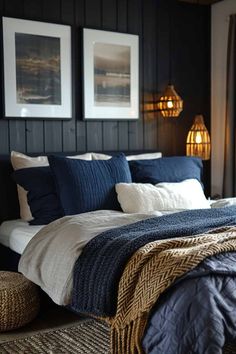 a bed with blue and white sheets in a bedroom next to two pictures on the wall