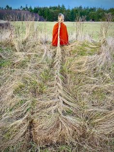 a person standing in a field with grass